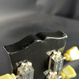 Close-up of a black electronic component with metallic contacts on a dark background