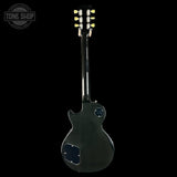 Black electric guitar on a white background with 'Tone Shop' logo.
