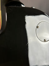 Close-up of a black and silver motorcycle part with visible wear.