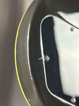 Close-up of a metallic object with screws on a gray background