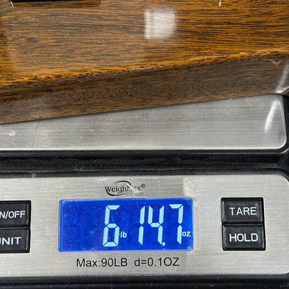 Digital kitchen scale displaying weight on a wooden surface