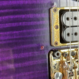 Close-up of a guitar's pickups and bracing on a purple guitar body.
