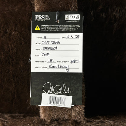 PRS guitar label on a brown textured background