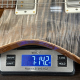 Guitar on a digital scale showing weight measurement