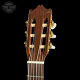 Close-up of a guitar headstock with a dark background