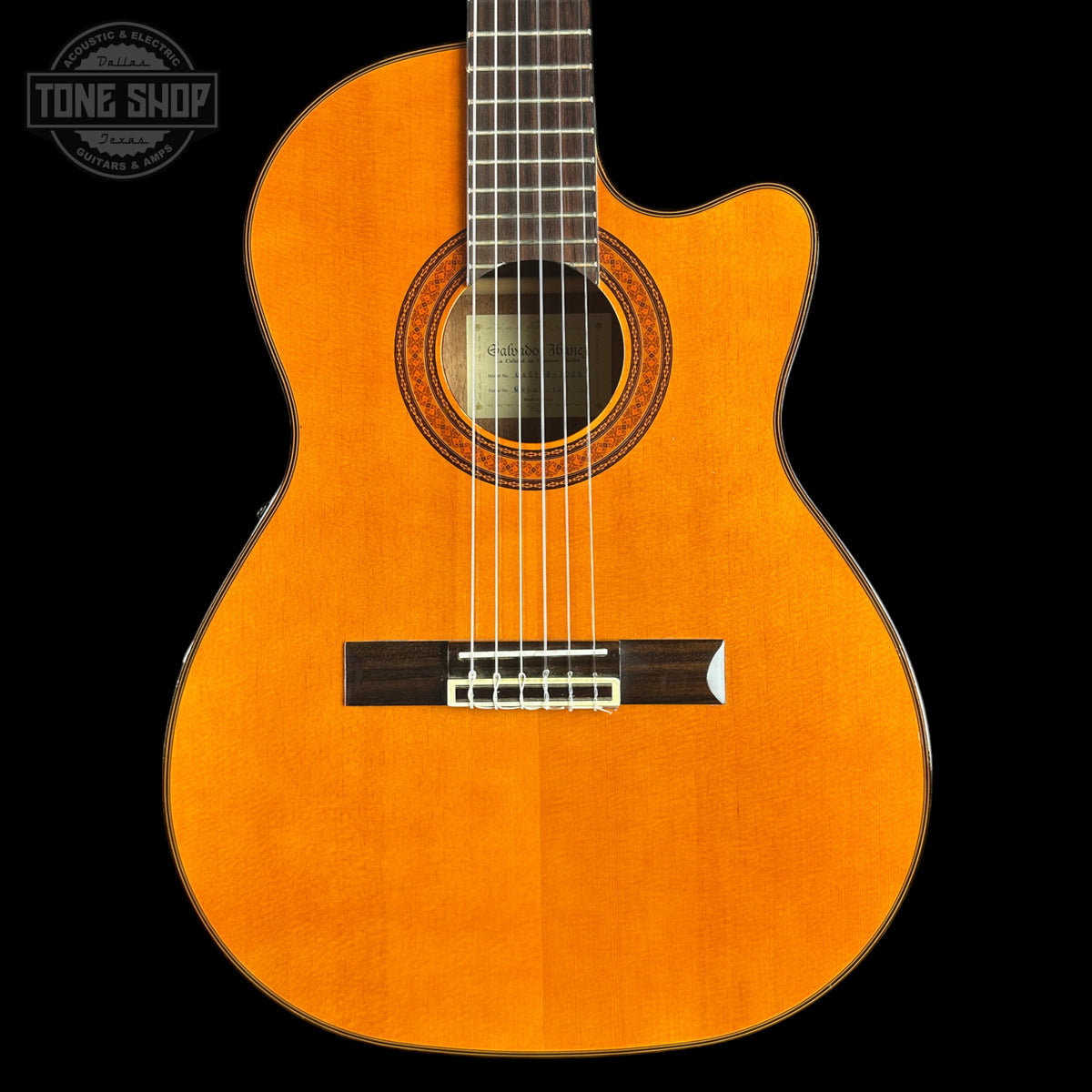 Acoustic guitar with a visible brand logo on a black background