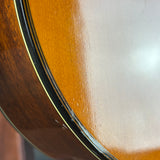 Close-up of a guitar's soundhole and wooden body