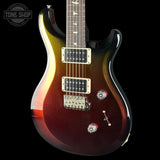 A PRS electric guitar with a glossy dark brown to black sunburst finish, featuring chrome hardware and a dark fretboard, shown against a solid black background with a Tone Shop watermark in the top left corner.