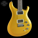 Yellow electric guitar with a 'Tone Shop' logo in the corner
