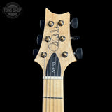 Close-up of the headstock of a guitar against a black background, showing a light natural wood finish, six tuning pegs, and a black trapezoidal pickguard with the model name 'NF33' printed on it. A signature is visible on the headstock, and a 'TONE SHOP' watermark is in the top-left corner.