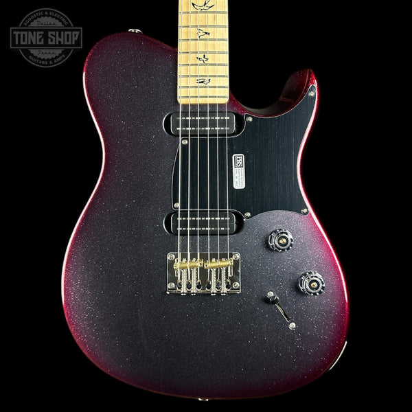 A close-up of a Fender Telecaster-style electric guitar body with a dark purple-to-red glitter finish, black pickguard, maple neck, and gold hardware, shown against a black background with a Tone Shop watermark in the upper left.
