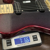 A close-up of a guitar body resting on a digital scale showing a weight of 7.66 kg (17 lbs 6 oz).