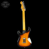 Electric guitar with a sunburst finish on a black background, featuring the Tone Shop logo.