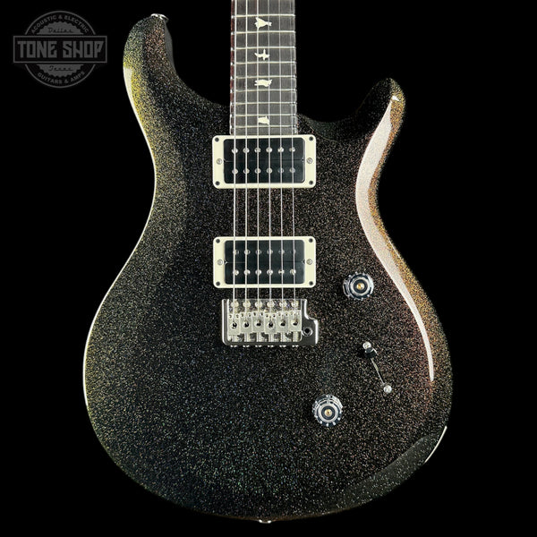 A black electric guitar with a glittery gold sparkle finish, featuring silver hardware and a dark fretboard, shown against a solid black background with a Tone Shop watermark in the top-left corner.