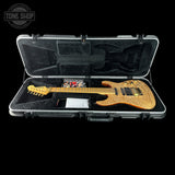 Electric guitar in a hard-shell case with 'Tone Shop' logo.