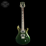 A green glitter electric guitar with a dark fretboard and white hardware, shown against a solid black background with a Tone Shop watermark in the top left corner.