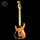 Wooden electric guitar on a black background with 'Tone Shop' logo.