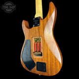 Wooden electric guitar with visible brand logo on a black background