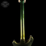 Close-up of the neck and lower body of a metallic gold electric guitar with a green glitter finish on the headstock, shown against a solid black background. A 'TONE SHOP' watermark is visible in the top-left corner.