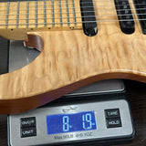 Electric guitar on a digital scale displaying weight