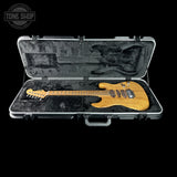 Electric guitar in a hard-shell case with 'Tone Shop' logo.