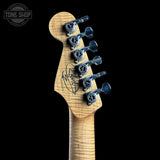 Guitar headstock with tuning pegs on a black background, featuring the Tone Shop logo.