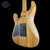 Wooden electric guitar body with visible brand logo on a white background