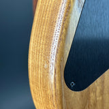 Close-up of a wooden object with a black component on a dark background