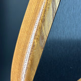Close-up of a wooden surface with a dark blue or black background