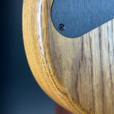 Close-up of a wooden product with a metallic component on a dark background