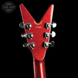 Close-up of the headstock of a red glitter electric guitar against a solid black background, showing six silver tuning pegs and gold 'MADE IN U.S.