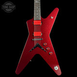 A red glitter electric guitar with a star-shaped body, black pickguard, and bright red humbucker pickups, shown against a solid black background with a Tone Shop watermark in the top left corner.