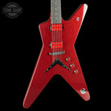 A red glitter electric guitar with a star-shaped body, red humbucker pickups, and chrome hardware, shown against a solid black background with a Tone Shop watermark in the top-left corner.