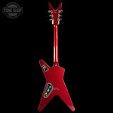 A red glitter electric guitar shown from the back against a solid black background, featuring a distinctive angular body and headstock.