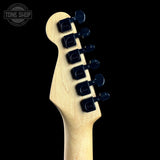 Guitar headstock with tuning pegs on a black background, featuring the Tone Shop logo.