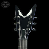 Close-up of a black electric guitar headstock featuring a white wing logo and the word 'DEADLY' in white, with six silver tuning pegs and strings against a black background.
