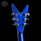 Close-up of the headstock of a blue glitter electric guitar against a black background, showing six silver tuning pegs and 'MADE IN USA' text. A Tone Shop watermark is visible in the top left corner.