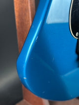 Close-up of a blue object with a metallic finish on a wooden surface