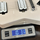 Close-up of a guitar body and pickups resting on a digital scale showing a weight of 10.31 lbs.