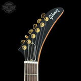 Gibson guitar headstock with brand logo on a black background