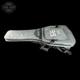 A light gray guitar gig bag with black zippers and straps, featuring a white 'GS' logo on the front pocket, shown against a solid black background with a Tone Shop watermark in the top left corner.
