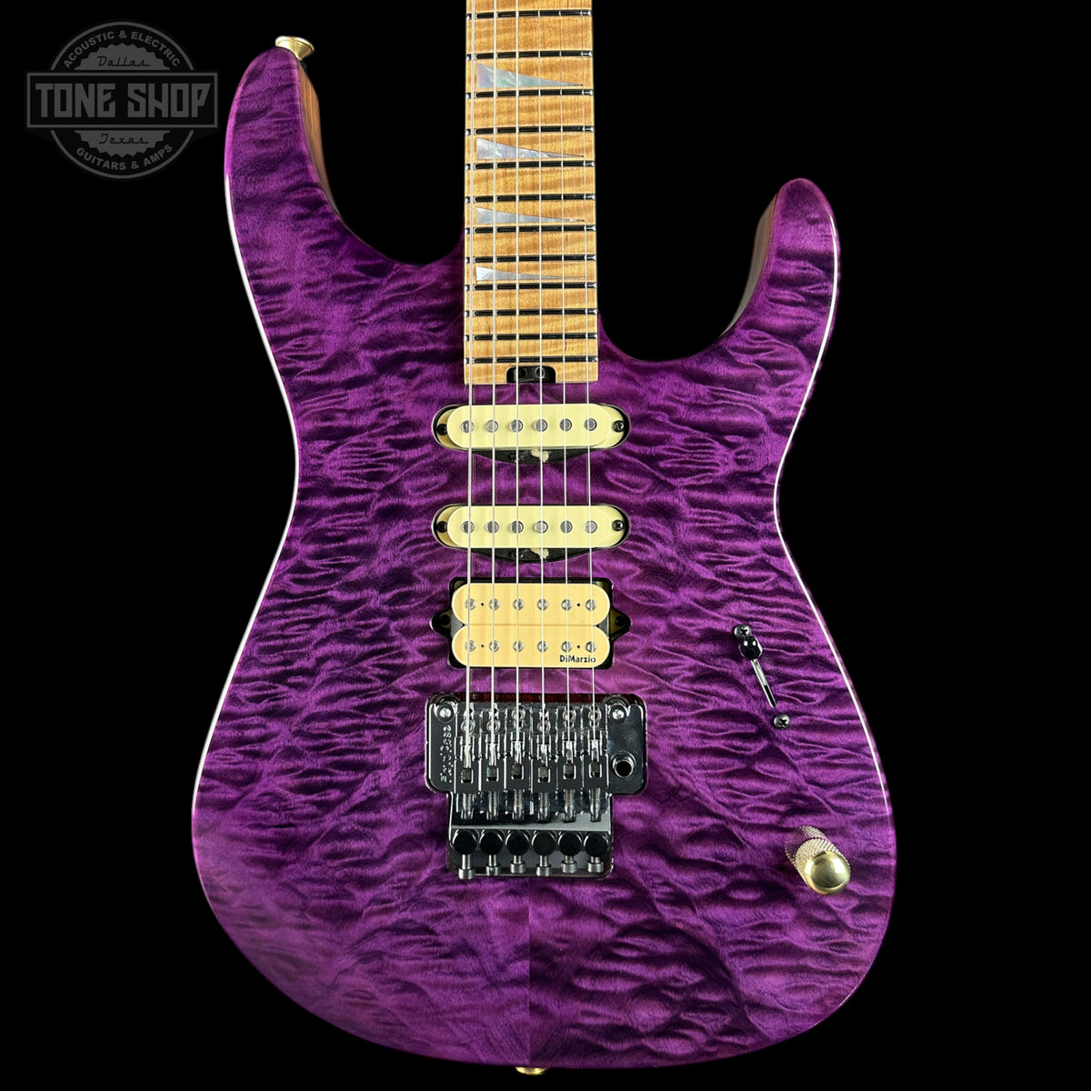 Purple electric guitar with a wavy finish on a black background, featuring the Tone Shop logo.