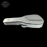 A light gray quilted ukulele or guitar case with a zippered top and carrying handle, shown against a solid black background. A Tone Shop logo is visible in the top-left corner.