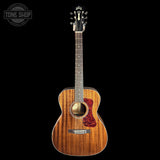 A Martin D-215 acoustic guitar with a natural wood finish and a red pickguard, shown against a solid black background with a Tone Shop watermark in the top left corner.