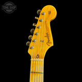 Close-up of a Fender guitar headstock on a black background with 'Tone Shop' logo.