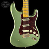 Green electric guitar with a worn finish on a black background, featuring 'Tone Shop' branding.
