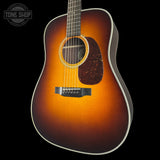 Acoustic guitar with a sunburst finish on a black background, featuring the Tone Shop logo.
