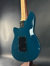 Blue electric guitar on a gray background