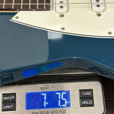 Guitar on a digital scale displaying weight