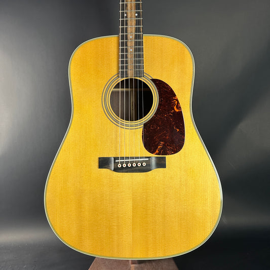 Acoustic guitar with a wooden finish on a dark background